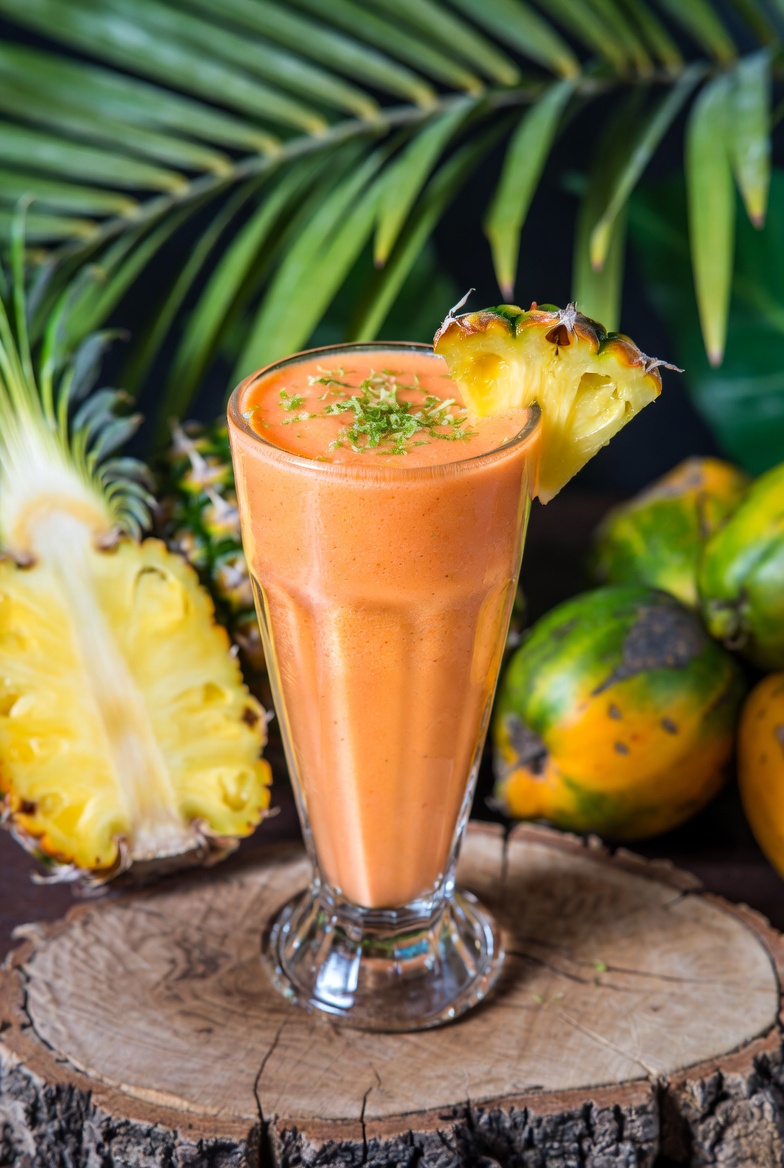 Equatorial Guinea Malamba Palm Fruit-Pineapple Smoothie Recipe Equatorial Guinea Malamba Palm Fruit-Pineapple Smoothie in a tall glass with fresh pineapple and palm leaves